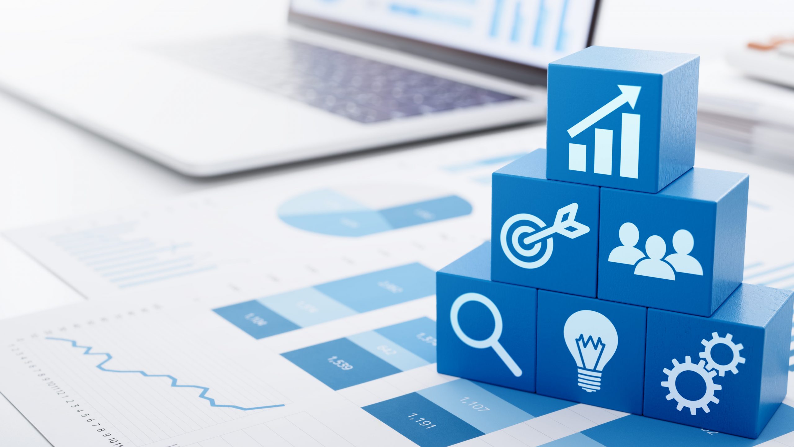 Business strategy for marketing and management. laptop in background statements and blue blocks with images
