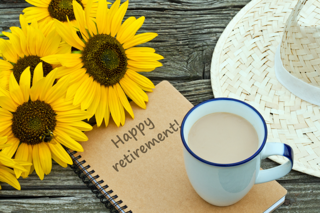 Happy retirement notebook Sunflowers, a cup of coffee and a straw hat.