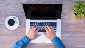 Person typing on a laptop.