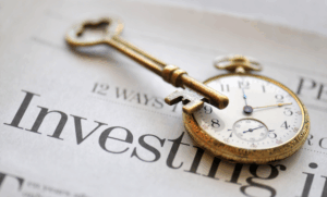 Investing newspaper with watch